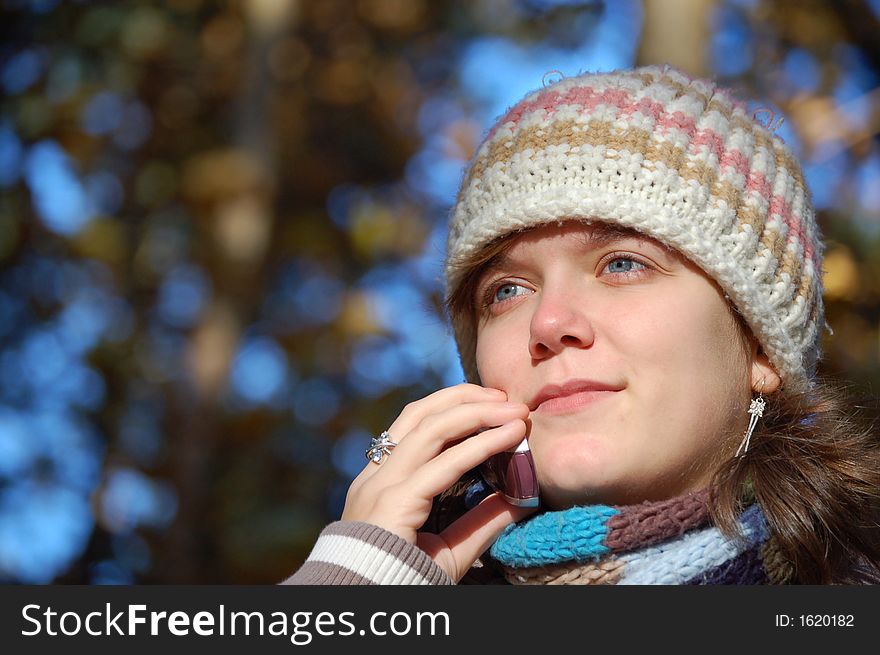 Girl talking on her cell phone in the park. Girl talking on her cell phone in the park