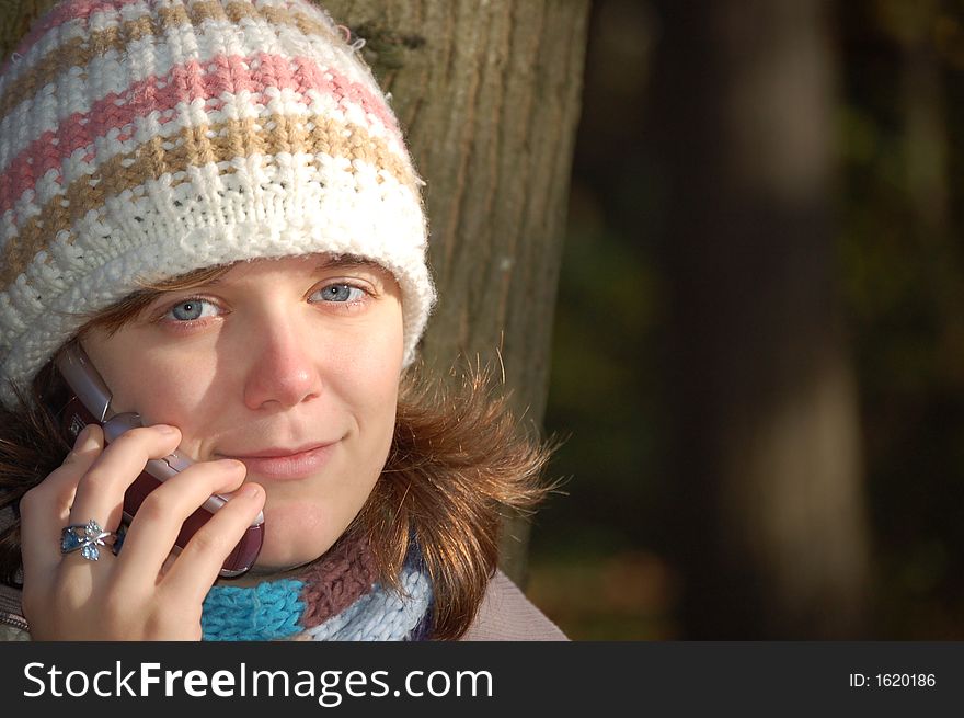 Girl talking on her cell phone in the park. Girl talking on her cell phone in the park