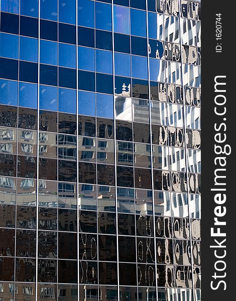 Blue sky reflected in a glass office building. Blue sky reflected in a glass office building