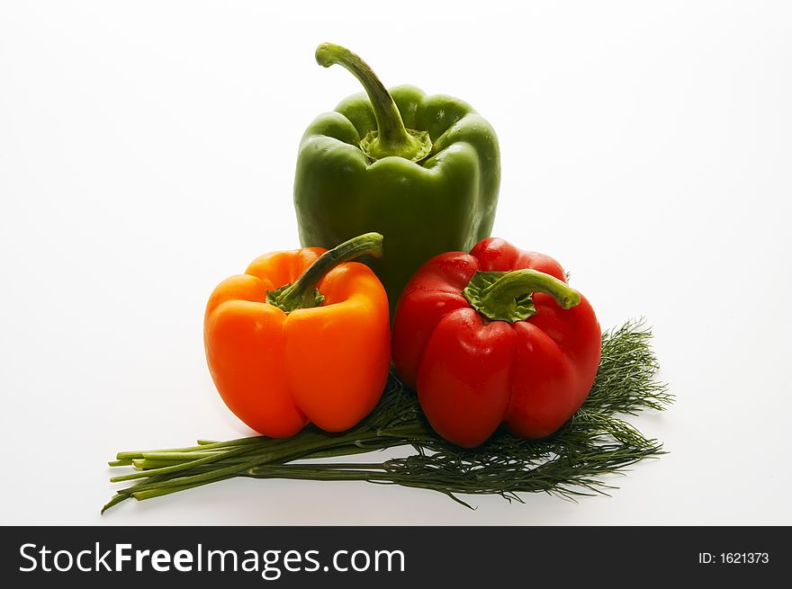 Three multi-coloured sweet pepper and bunch of fennel