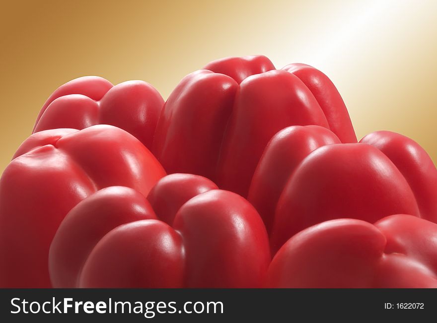 Group of red sweet peppers on a golden background. Group of red sweet peppers on a golden background