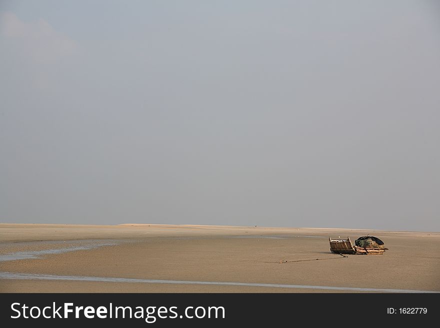 On the beach, the boat under the blue sky