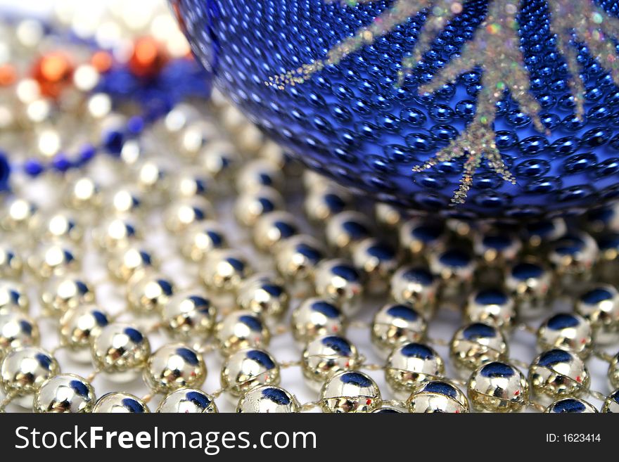 Dark blue christmas sphere on a background of a brilliant celebratory beads