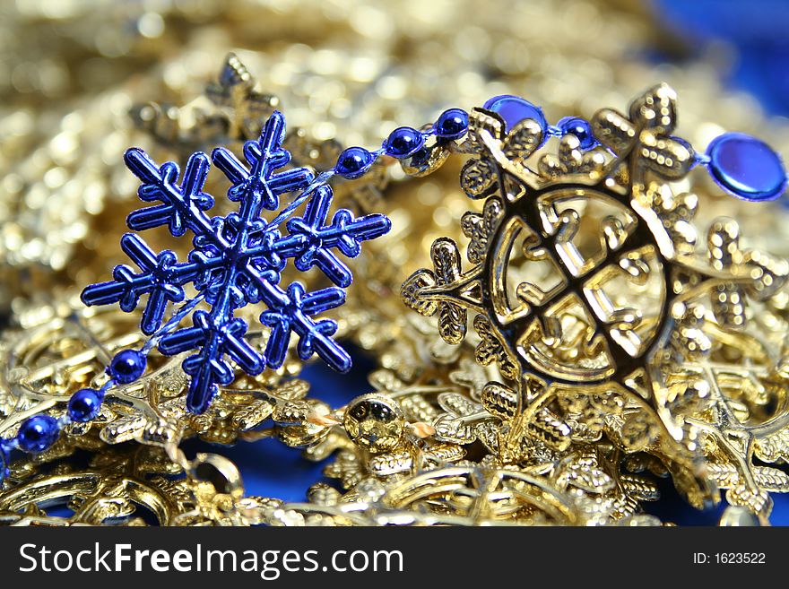 Christmas garlands of dark blue and yellow color in the form of snowflakes