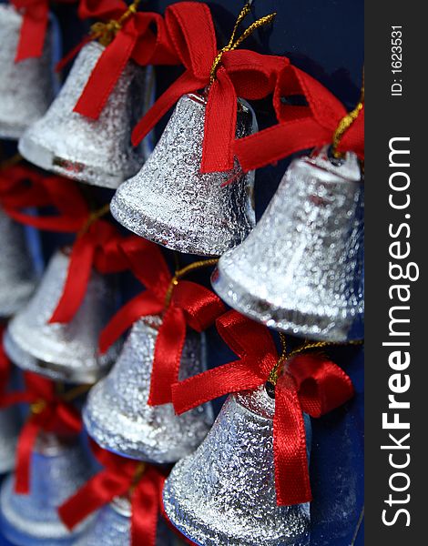 Christmas handbells of silvery color with red bows