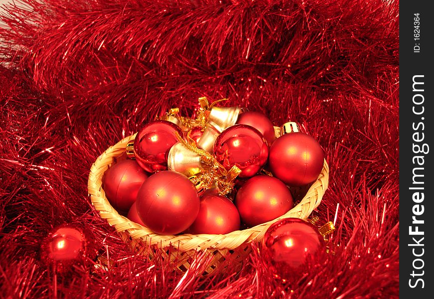 Red Christmas balls on a basket and garland