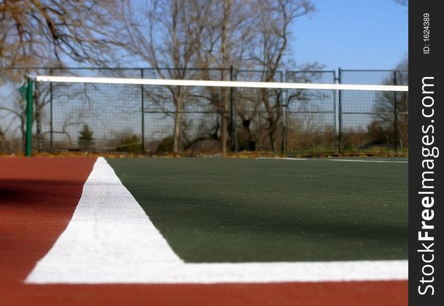 Ground level view of tennis court left boundary.