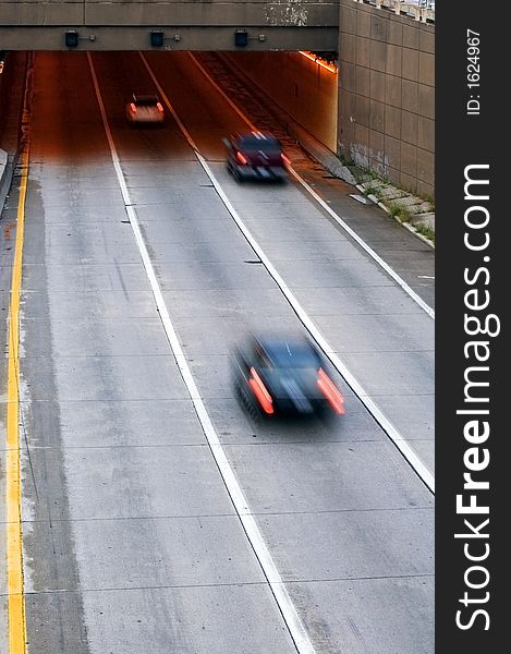 Vehicles drive into tunnel in light morning traffic. Vehicles drive into tunnel in light morning traffic