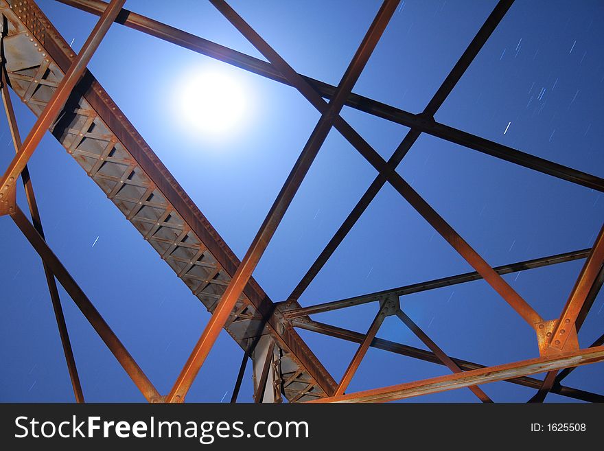 Moon rises over a metal frame. Moon rises over a metal frame