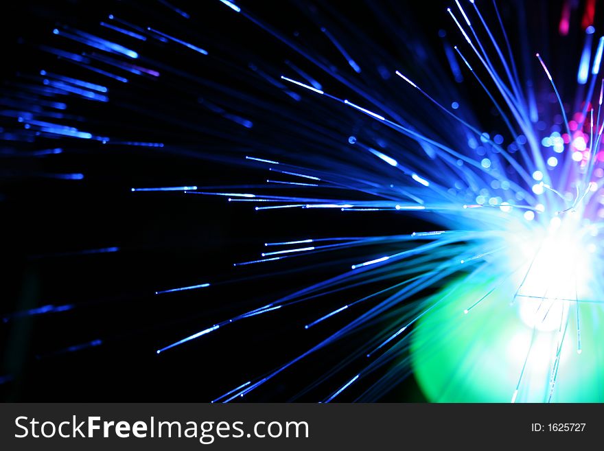 Optical cables in a decorative toy, black background. Optical cables in a decorative toy, black background