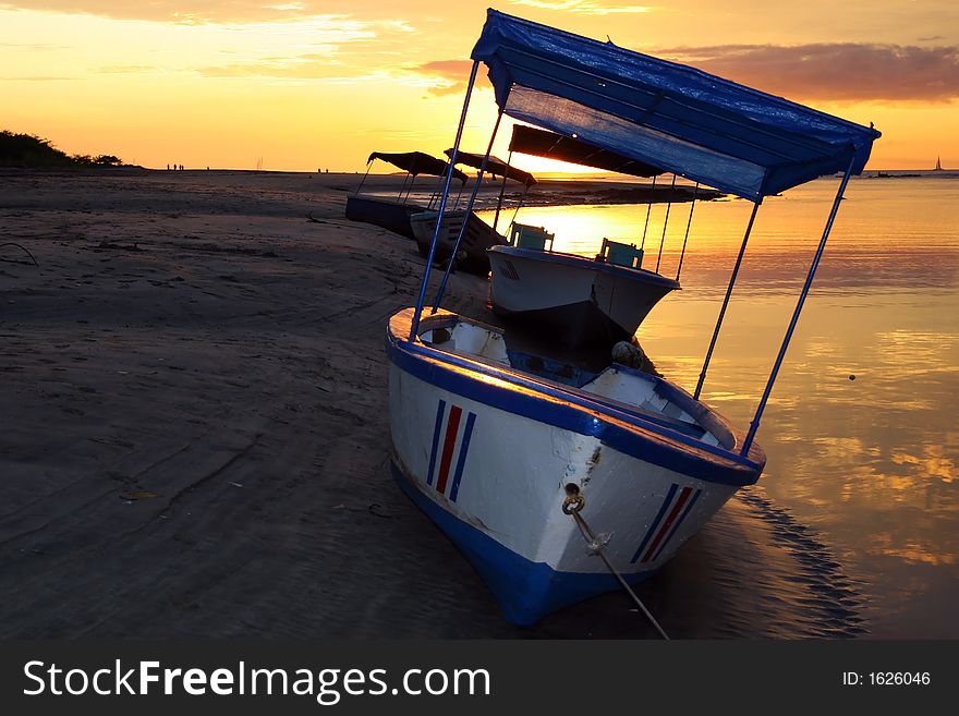 Beautiful sunset behind boat on tamarindo beach. Beautiful sunset behind boat on tamarindo beach