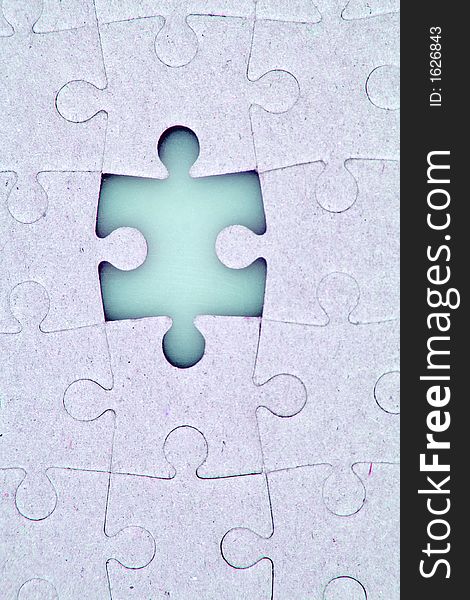 A jigsaw puzzle with a missing piece.