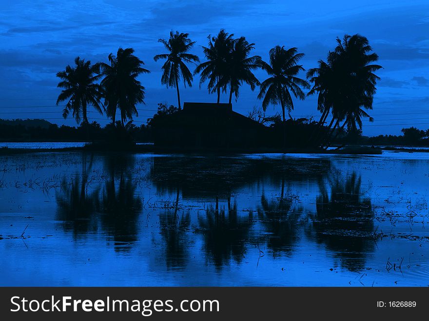 Traditional Malay village sunset view in silhouette. Traditional Malay village sunset view in silhouette.