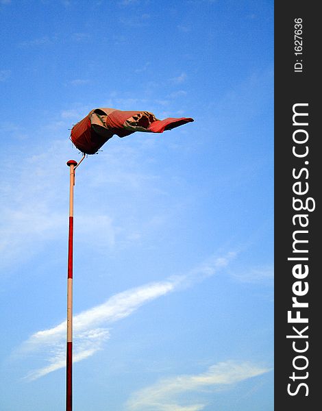 Torn windcone on a pole. Torn windcone on a pole