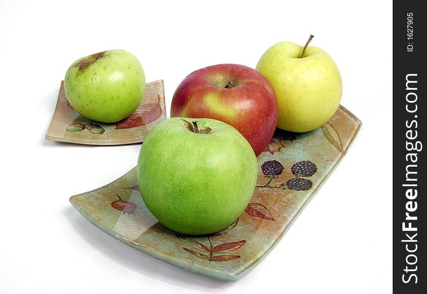 Decorated tray with red, geen and yellow apples.