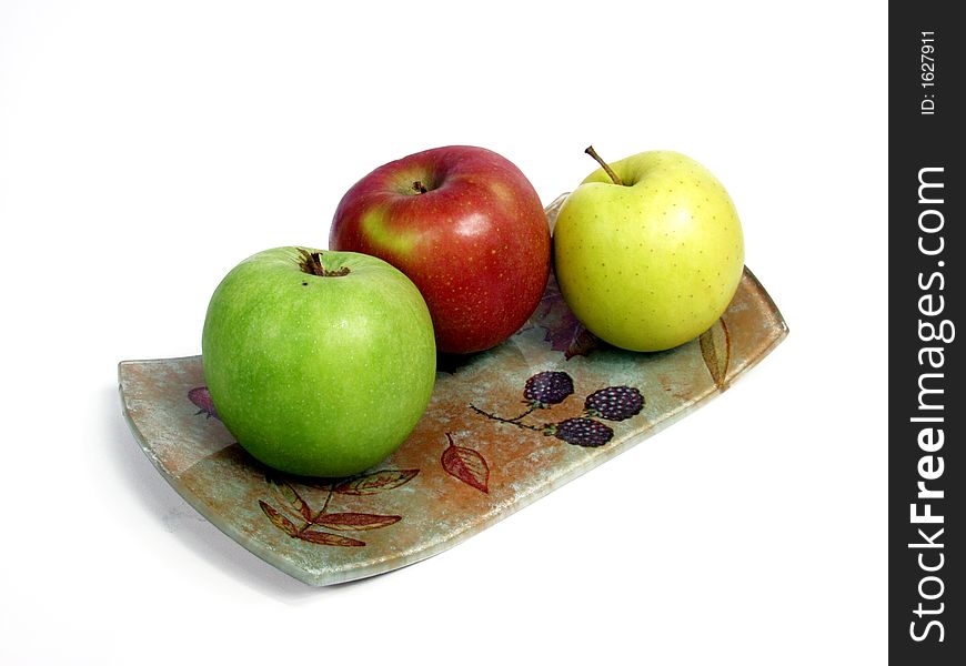 Decorated tray with red, geen and yellow apples.