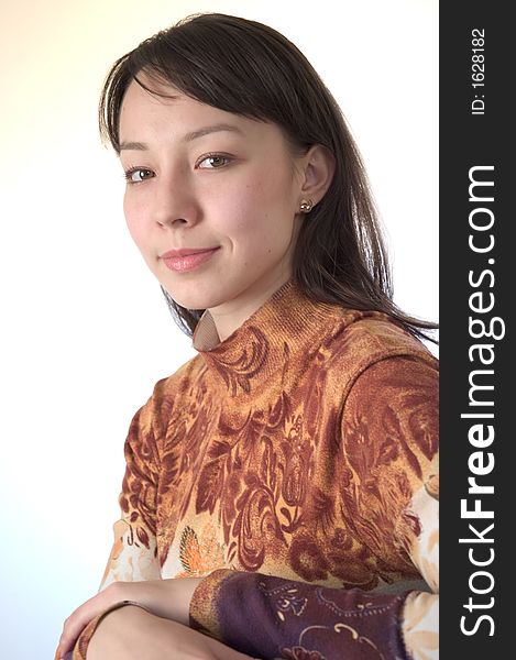 Young brunette shoulders portrait looking straight at the camera. Young brunette shoulders portrait looking straight at the camera