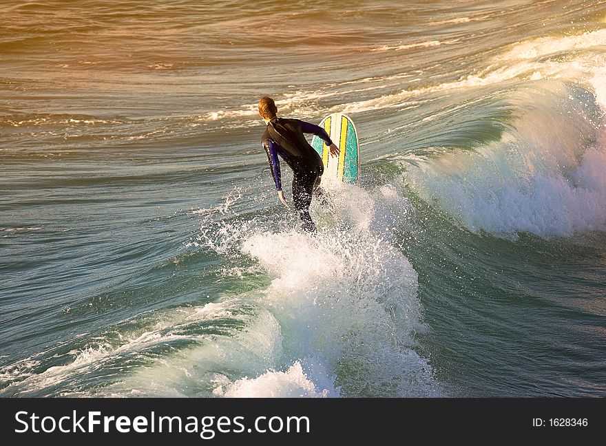 A photo of a surfer at sunset outside San Diego. A photo of a surfer at sunset outside San Diego