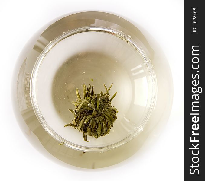 A glass of artisan blooming tea on white