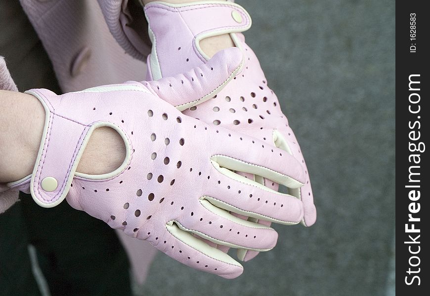 Women hand with leather new pink glovers for drive. Women hand with leather new pink glovers for drive