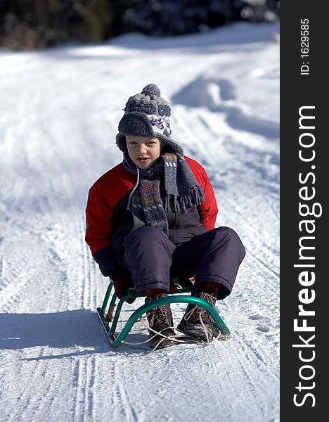 Boy on sled on winter road