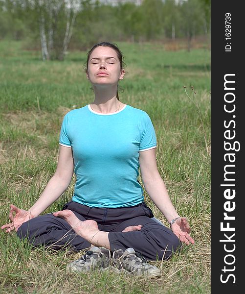 Woman relaxing in yoga pose after fitness outdoors. Woman relaxing in yoga pose after fitness outdoors