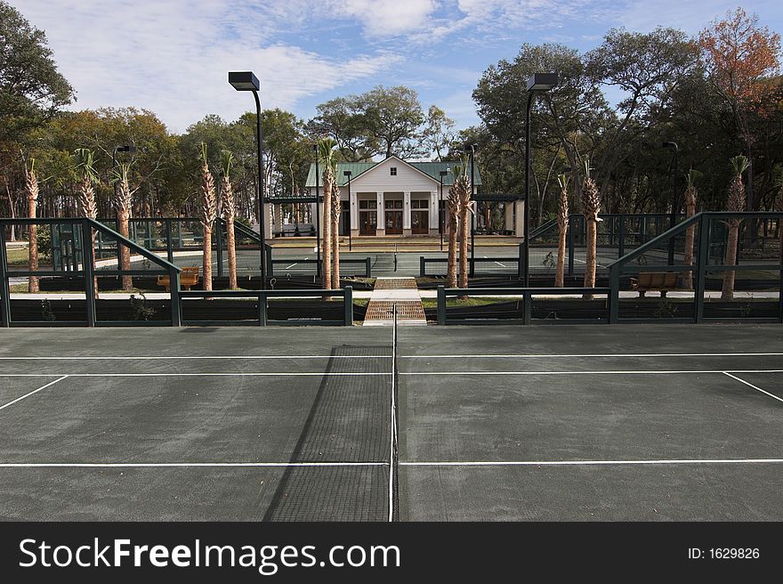 Exclusive tennis club with multiple courts and clubhouse. Exclusive tennis club with multiple courts and clubhouse
