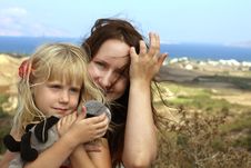 Woman Embracing A Child On Sea Background Stock Images Woman Embracing A Child On Sea Background Stock Images