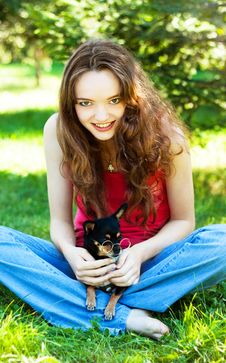 Girl Lying On The Grass Next To A Dog Stock Images