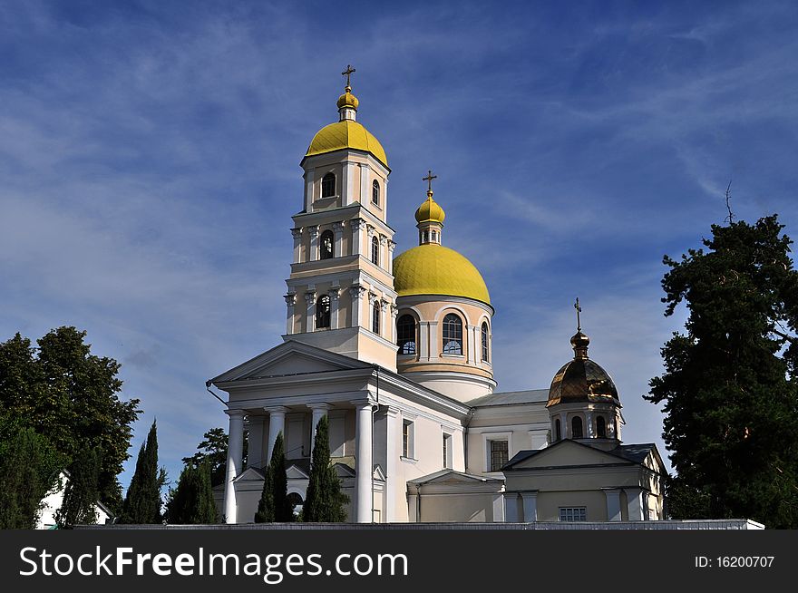 Beautiful orthodox church of Maria Magdaliny with a bell tower on a background dark blue sky and white clouds in town White Church in Ukraine