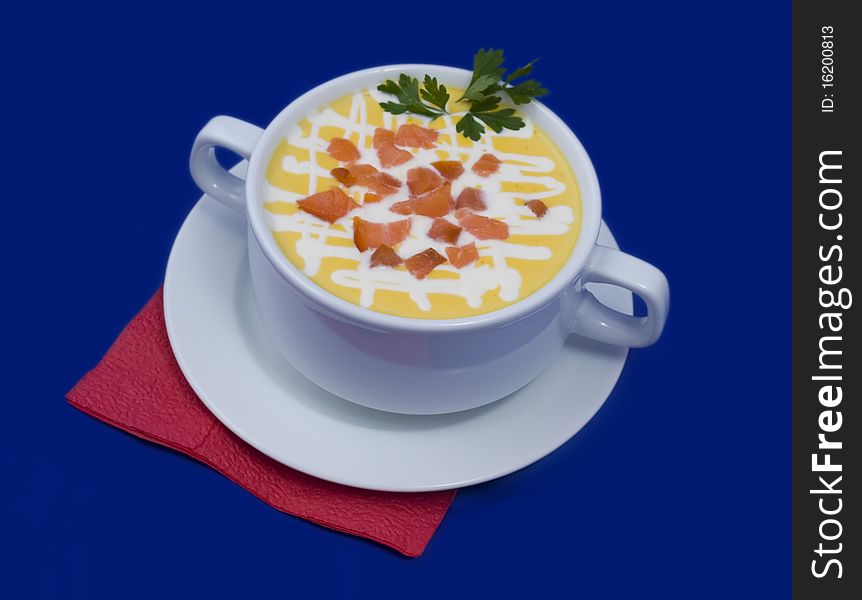 Soup photo in a bowl on a blue background. Soup photo in a bowl on a blue background