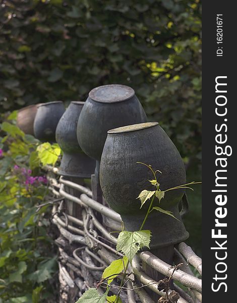 Ceramic pots on the wicker fence