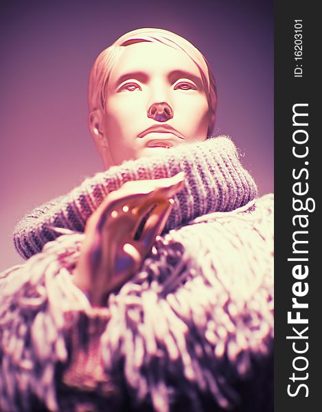 Fashionable portrait of a woman, wearing a beautiful neck wool sweater. Violet tone and  background. Fashionable portrait of a woman, wearing a beautiful neck wool sweater. Violet tone and  background