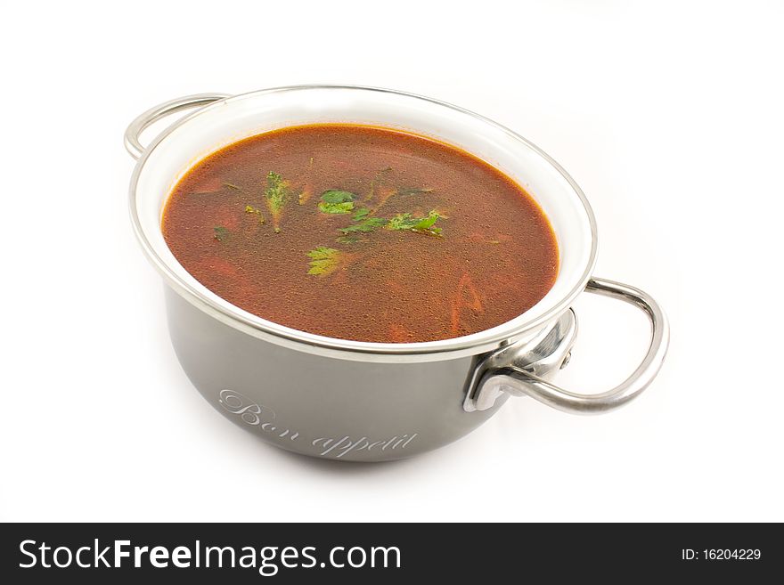 Fresh hot beet soup with parsley in a saucepan