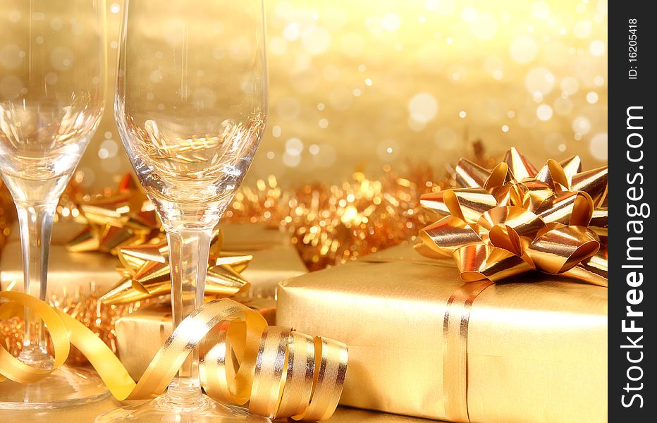 Studio photo of empty champagne glasses and golden decoration on background. Studio photo of empty champagne glasses and golden decoration on background