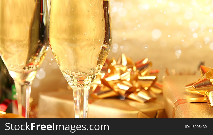 Studio photo of champagne glasses and golden decoration on background. Studio photo of champagne glasses and golden decoration on background