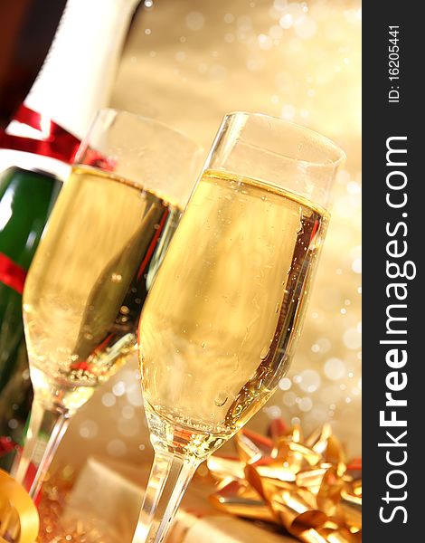 Studio photo of champagne glasses and golden decoration on background. Studio photo of champagne glasses and golden decoration on background