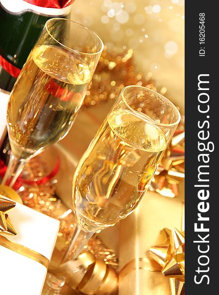 Studio photo of champagne glasses and golden decoration on background. Studio photo of champagne glasses and golden decoration on background