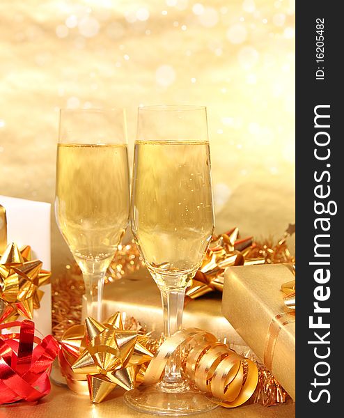 Studio photo of champagne glasses and golden decoration on background. Studio photo of champagne glasses and golden decoration on background