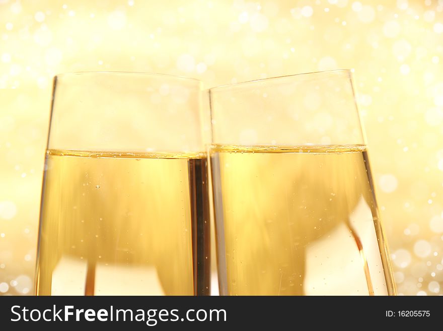 Studio photo of champagne glasses on gold background. Studio photo of champagne glasses on gold background