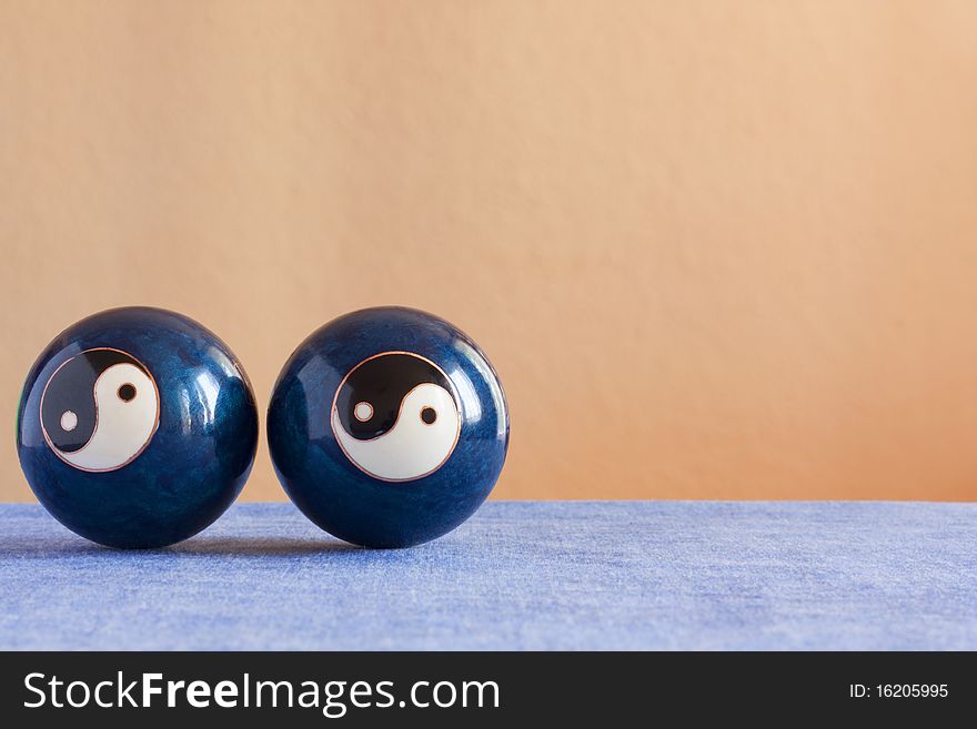 Two chineese yin-yang  balls on a table. Two chineese yin-yang  balls on a table