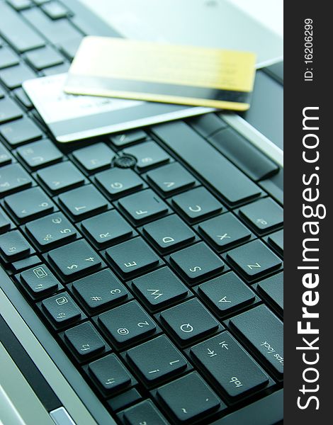 Laptop keyboard with gold and silver credit cards. Laptop keyboard with gold and silver credit cards