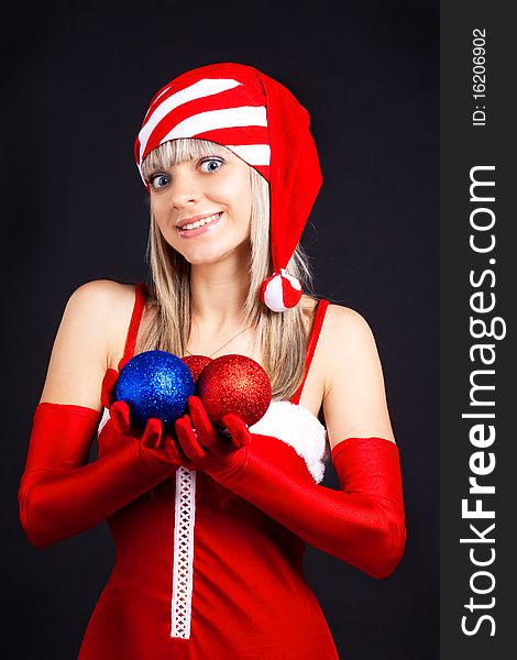 Santa girl holding a Christmas ball, Christmas toys.Holidays New Year and Christmas