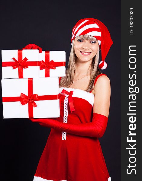 Santa girl holding the box with gifts. Holidays New Year and Christmas