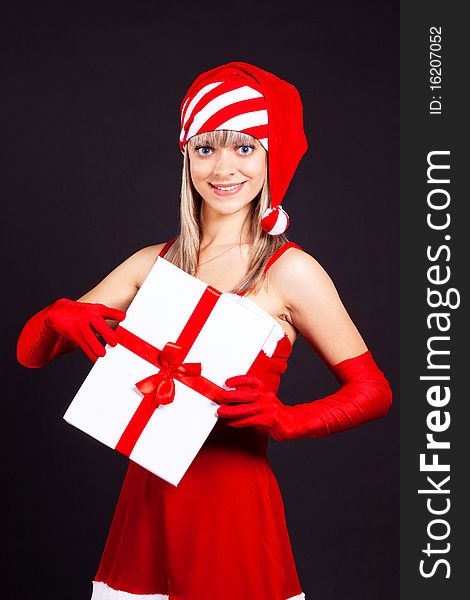 Santa girl holding the box with gifts.  Holidays New Year and Christmas