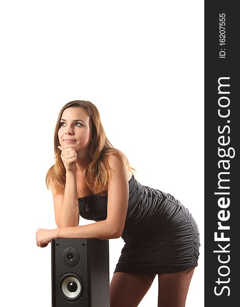 A young girl near a speaker on the white isolated background. A young girl near a speaker on the white isolated background