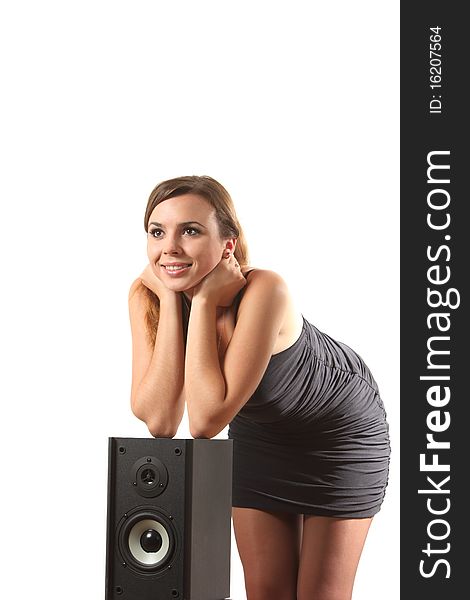 A young girl near a speaker on the white isolated background. A young girl near a speaker on the white isolated background