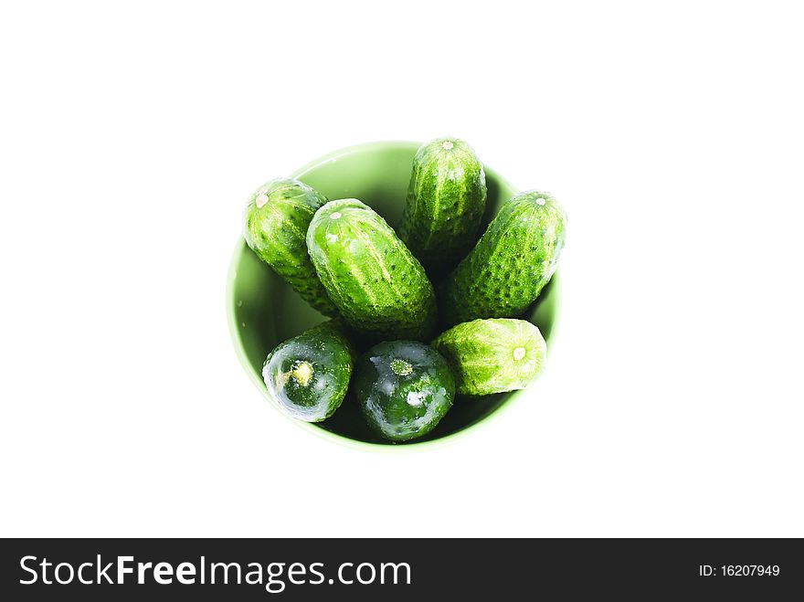 green wet cucumbers in green bowl