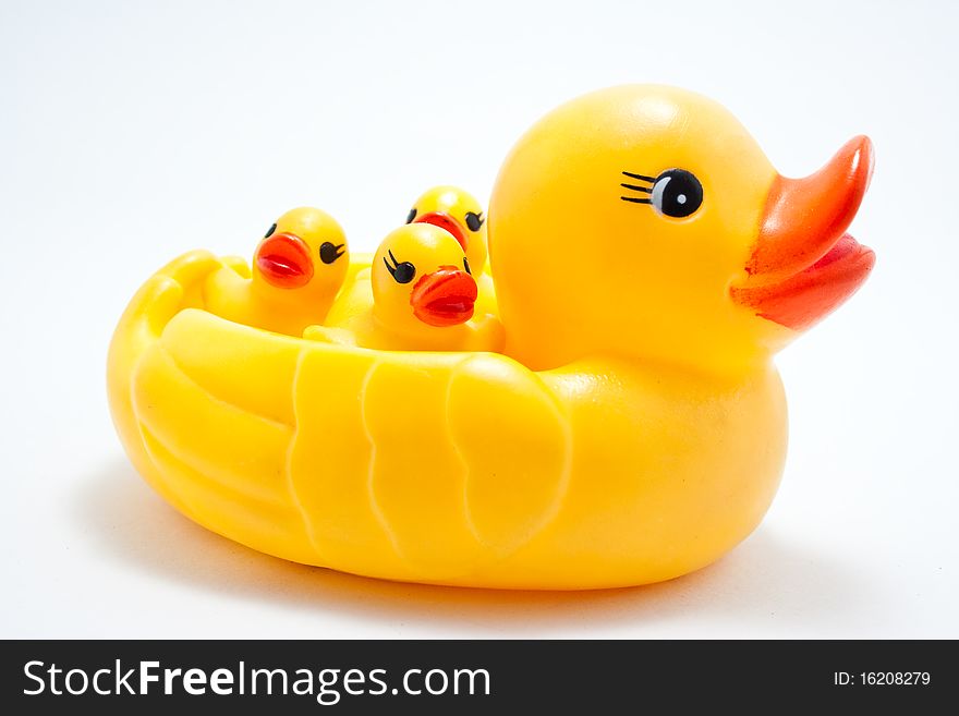 Plastic yellow duck toy on white background