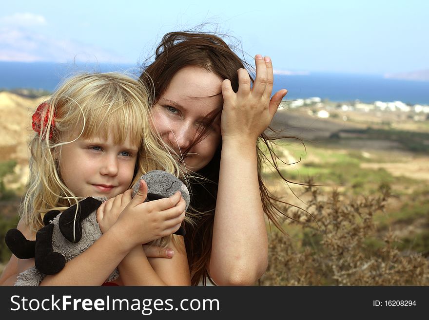 Woman Embracing A Child On Sea Background